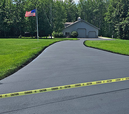 Residential sealcoating protects against sun damage, moisture, and daily wear while restoring that clean, dark finish that boosts curb appeal and adds years to your pavement's life.